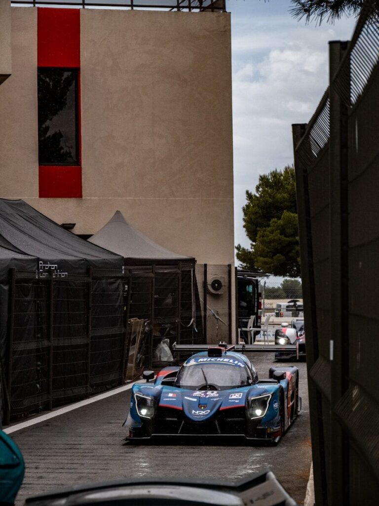 Race cars are driving along the track.