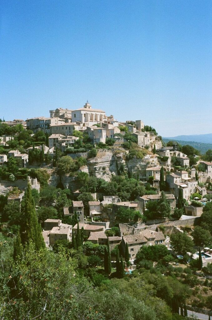A village on top of a hill surrounded by trees